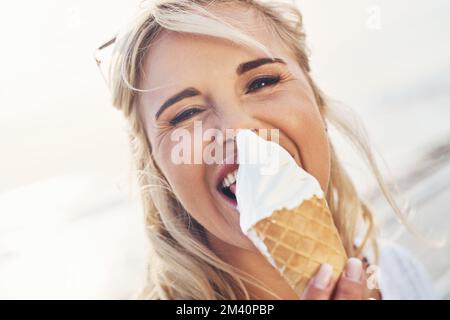 Forget the diamonds, ice cream is a girls best friend. a young woman enjoying ice cream outdoors. Stock Photo