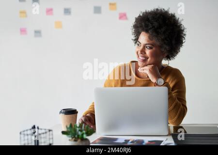 Everything is coming together perfectly. an attractive young businesswoman feeling cheerful while working in her office. Stock Photo