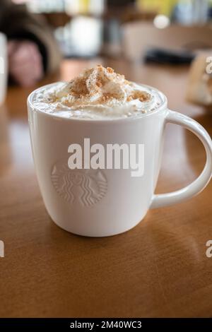 Starbucks coffee caramel latte white mug in Starbucks Cafe. Starbucks is the largest coffeehouse company in the world-Vancouver BC Canada-December 2,2 Stock Photo