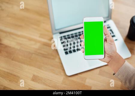 Make use of all your connections in business. an unrecognizable businesswoman using a cellphone and laptop in her office. Stock Photo