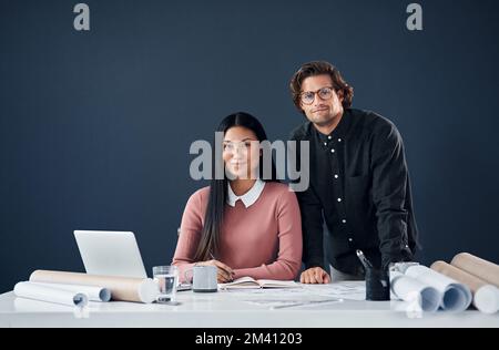 It looks easy when you put in the hard work. Portrait of two young architects working together in their office. Stock Photo