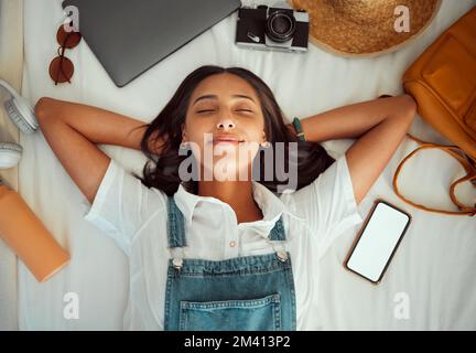 Top view, relax and woman sleeping on bed at hotel on vacation, holiday or trip. Phone mockup, travel dream and happy female in bedroom at motel Stock Photo