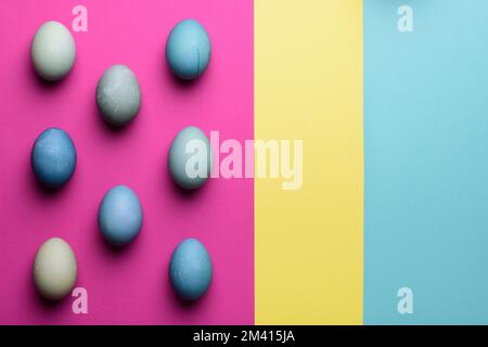 Happy Easter pastel coloured background. Hand painted Easter eggs abstract minimal concept. Stock Photo