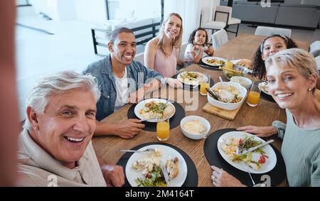 Big family, lunch and selfie with food on table in home dining room. Fine dining, happy memory and grandma, grandpa and father, mother and girls with Stock Photo