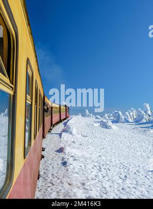 Steam train during winter in the snow in the Harz national park Germany, Steam train Brocken Bahn on the way through the winter landscape at the Brocken mountain, Brocken, Harz Germany Stock Photo