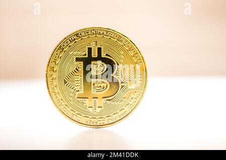Bitcoin gold coin placed on white and brown background. Gold coin of cryptocurrency Stock Photo