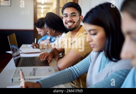 Education, university and students in lecture studying and learning business management. Scholarship, college and portrait of happy man with laptop Stock Photo