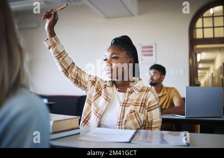 College student, black woman and hands to answer question in classroom for teaching, school education or learning. University student with raised hand Stock Photo