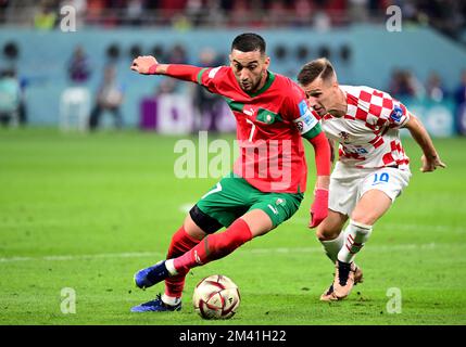 DOHA, QATAR - DECEMBER 17: Hakim Ziyech of Morocco competes for the ball with Mislav Orsic of Croatia ,during the FIFA World Cup Qatar 2022 3rd Place match between Croatia and Morocco at Khalifa International Stadium on December 17, 2022 in Doha, Qatar. (Photo by MB Media) Stock Photo