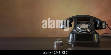 Old telephone set and wrist watch on a wooden table, banner. Vintage still life Stock Photo