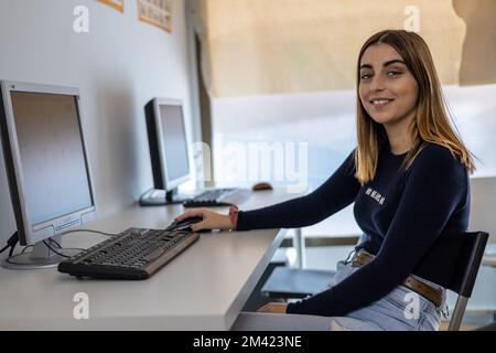 young woman student using computer in class Stock Photo