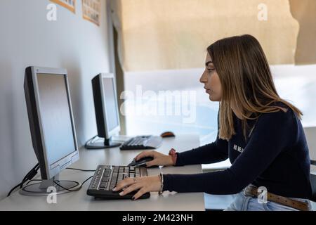 young woman student using computer in class Stock Photo