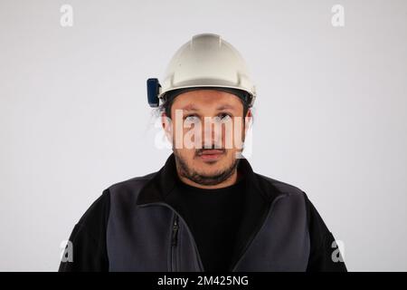 Portrait of a man with a hard cap on white isolated background. Stock Photo