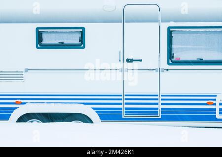 Snow covered caravan at parking place Stock Photo