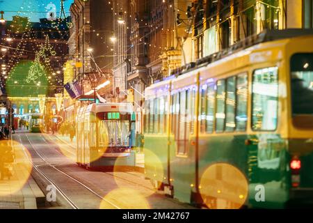 Helsinki, Finland. Bokeh Effect Tram Departs From Stop On Aleksanterinkatu Street. Evening Christmas Xmas New Year Festive Illumination. Boke View Stock Photo