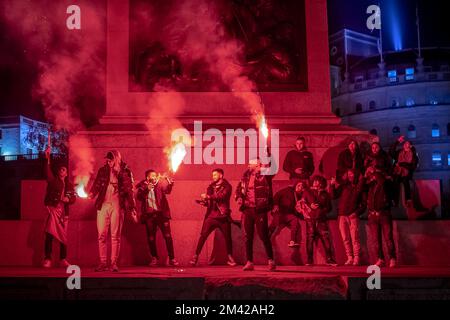 London, UK. 17th December 2022. World Cup: Morocco supporters let off post-match fireworks in Trafalgar Square after losing 2-1 to Croatia in the third place finish at the 2022 World Cup in Qatar. Credit: Guy Corbishley/Alamy Live News Stock Photo