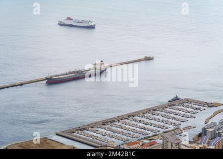 Port of Gibraltar with large ships docked alongside small pleasure boats in the marina. Stock Photo