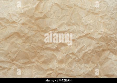 Background of crumpled parchment or craft paper in brown color Stock Photo