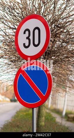 30 kilometres speed limit and no parking road signs. Vertical Stock Photo