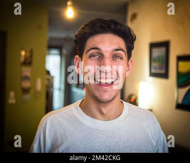 Attractive green eyed young man smiling very happy Stock Photo