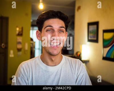 Attractive green eyed young man smiling very happy Stock Photo
