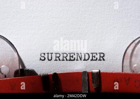 Surrender word written with a typewriter. Stock Photo