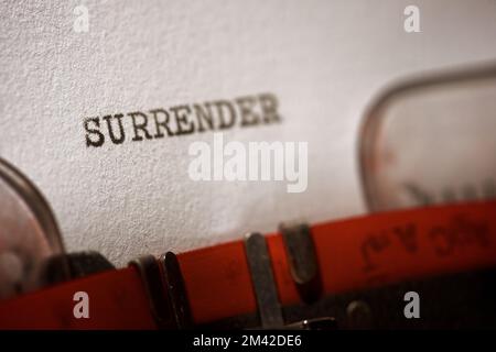 Surrender word written with a typewriter. Stock Photo