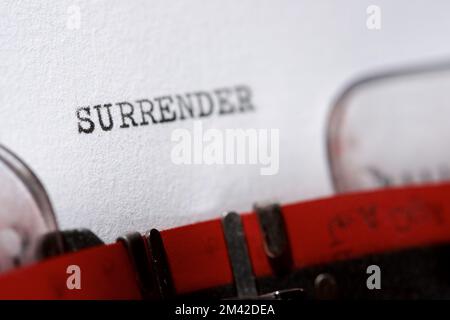 Surrender word written with a typewriter. Stock Photo