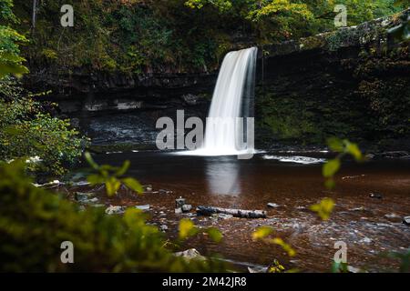Sgwd Gwladys or Lady Falls along the Four Waterfalls walk, Waterfall Country, Brecon Beacons national park, South Wales, the United Kingdom. Long exposure. Stock Photo