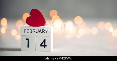 Small red heart on wooden calendar blocks. Valentine's day background Stock Photo