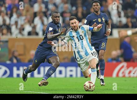 Lusail Iconic Stadium, Lusail, Qatar. 18th Dec, 2022. FIFA World Cup Football Final Argentina versus France; Lionel Messi of Argentina is challenged by Dayot Upamecano of France Credit: Action Plus Sports/Alamy Live News Stock Photo