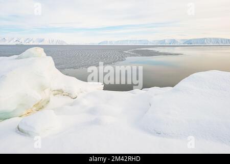 Open water at fjord in front of mountain range, Greenland. Stock Photo