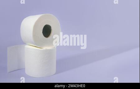 Rolls of toilet paper. Two rolls of toilet paper on a purple background. copy space Stock Photo