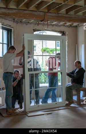 Workers are installing a window Stock Photo