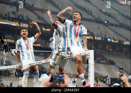 Argentina's Leandro Paredes (right) celebrates victory over France with Rodrigo De Paul and Paulo Dybala following the FIFA World Cup final at Lusail Stadium, Qatar. Picture date: Sunday December 18, 2022. Stock Photo