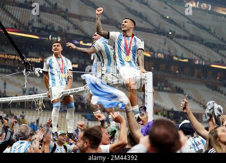 Argentina's Leandro Paredes (right) celebrates victory over France with Rodrigo De Paul and Paulo Dybala following the FIFA World Cup final at Lusail Stadium, Qatar. Picture date: Sunday December 18, 2022. Stock Photo