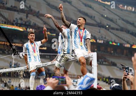 Argentina's Leandro Paredes (right) celebrates victory over France with Rodrigo De Paul and Paulo Dybala following the FIFA World Cup final at Lusail Stadium, Qatar. Picture date: Sunday December 18, 2022. Stock Photo