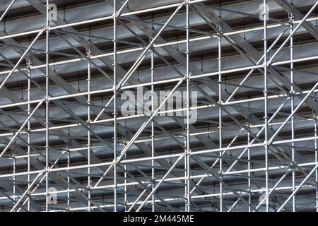 Metal pipe frame structure. Industrial construction from tubes raises upwards. Building process and joining elements view. Straight and inclined lines Stock Photo