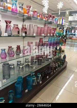 11.12.2022 Ukraine, Kharkiv, gift shop - a set of decorative glass pink vases. Pink glass vase with decorative lines around, isolated Stock Photo