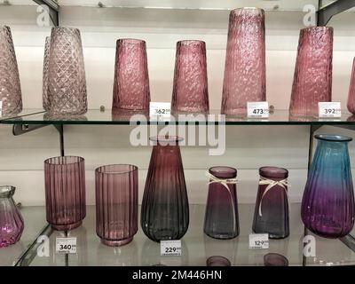11.12.2022 Ukraine, Kharkiv, gift shop - a set of decorative glass pink vases. Pink glass vase with decorative lines around, isolated Stock Photo