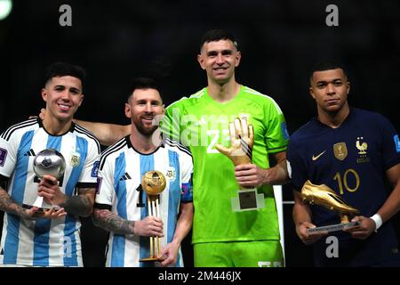 Argentina's Enzo Fernandez, young player award, Lionel Messi, golden ball, goalkeeper Emiliano Martinez, golden glove and France's Kylian Mbappe, golden boot, (left-right) pose with their awards following the FIFA World Cup final at Lusail Stadium, Qatar. Picture date: Sunday December 18, 2022. Stock Photo