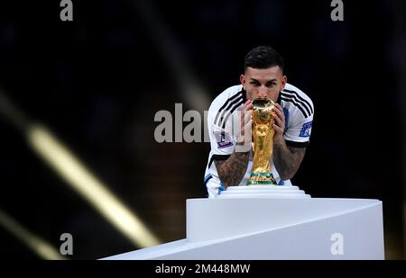 Argentina's Leandro Paredes kisses the World Cup trophy before the ceremony following FIFA World Cup final at Lusail Stadium, Qatar. Picture date: Sunday December 18, 2022. Stock Photo