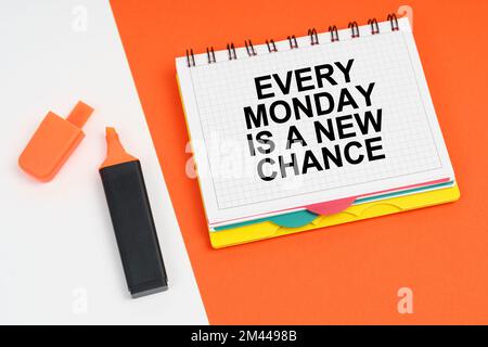 Business and finance concept. On a white-orange surface lies a marker and a notepad with the inscription - EVERY MONDAY IS A NEW CHANCE Stock Photo