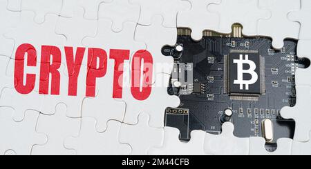 Business and technology concept. On the puzzles there is a processor with a bitcoin symbol and it says - Crypto Stock Photo