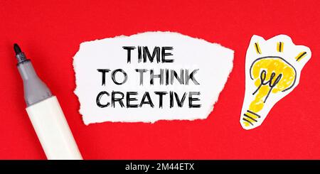 Business concept and idea. On a red surface lie a marker, a drawing of a light bulb and torn paper with the inscription - Time To Think Creative Stock Photo