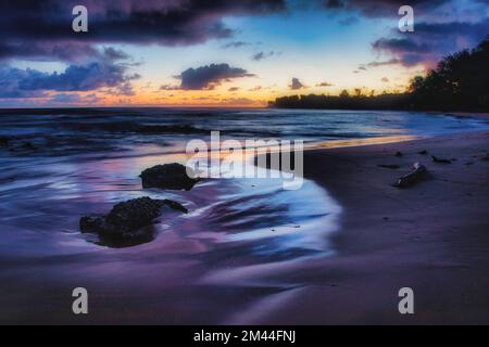 Sunrise reflects in the tide at Anohala Bay on the east coast of Kauai, Hawaii. Stock Photo