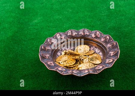 Fake gold coins in an old decorative metal plate Stock Photo - Alamy