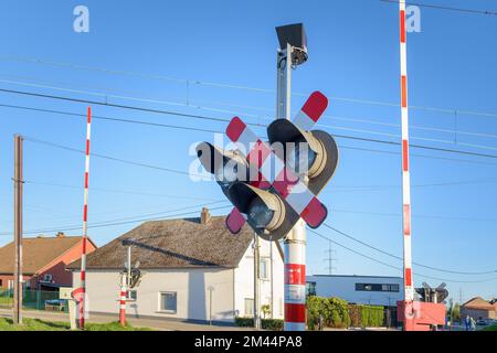 Sint-Truiden. Limburg - Belgium. 17-04-2022. Semaphore and barrier. Railway crossing. Warning road sign about the proximity of a railway crossing. Stock Photo