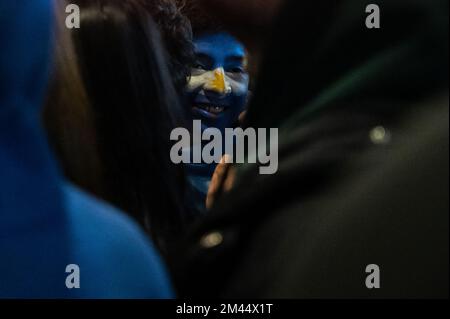 Madrid, Spain. 18th Dec, 2022. An Argentinian fan with his face painted is seen in a street during the final match between Argentina and France. Argentina won the FIFA World Cup Qatar 2022 defeating France on a match that ended in a 3-3 draw, winning the championship title after penalties (4-2). Credit: Marcos del Mazo/Alamy Live News Stock Photo