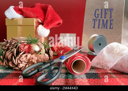 Gift boxes, wrapping paper, beautiful bags for Christmas goods on the table. Scissors, etc. Stock Photo